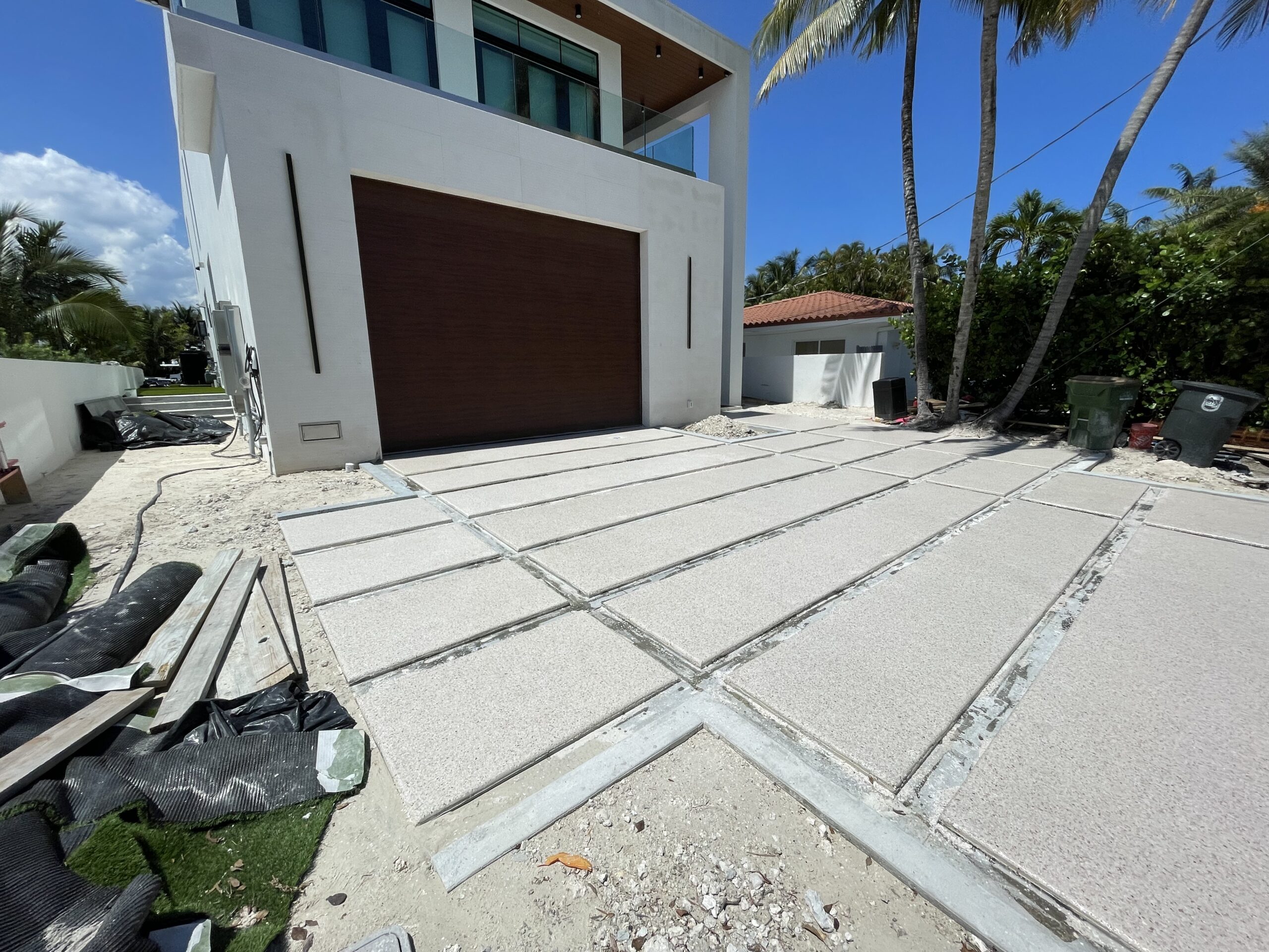 Installer detailing Residential Epoxy Garage Flooring edges inside a Kendall, FL home garage during final coating work