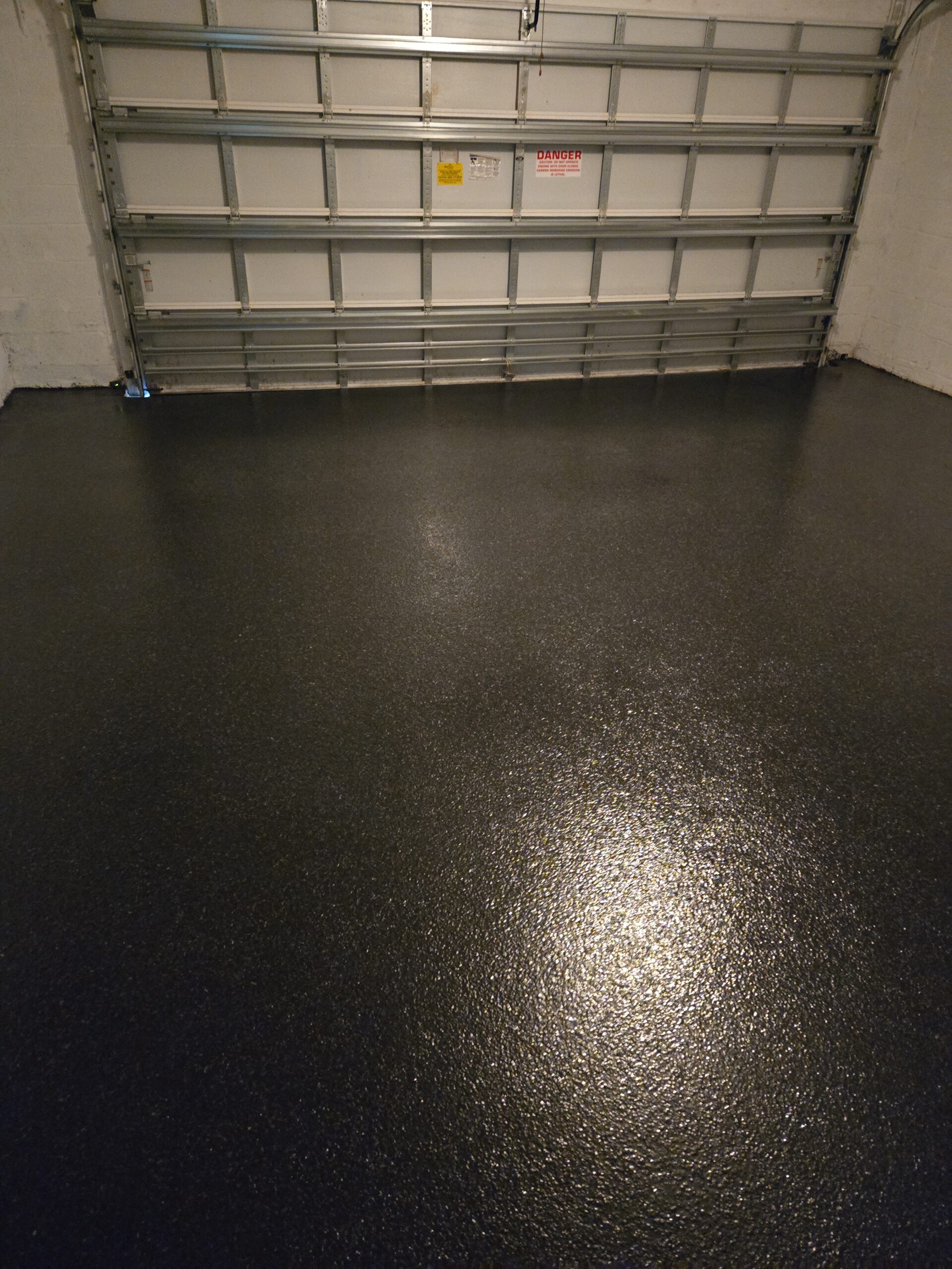 High-Gloss Epoxy Garage Flooring in Kendall, FL being rolled onto a garage slab as the surface turns glossy