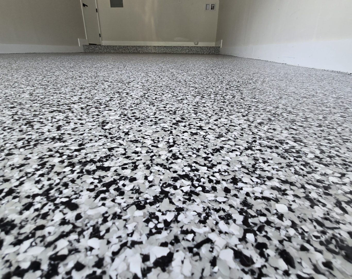 Expertly applied durable epoxy garage flooring by Carbon Concrete Coatings, providing a tough and stylish surface in a North Miami home