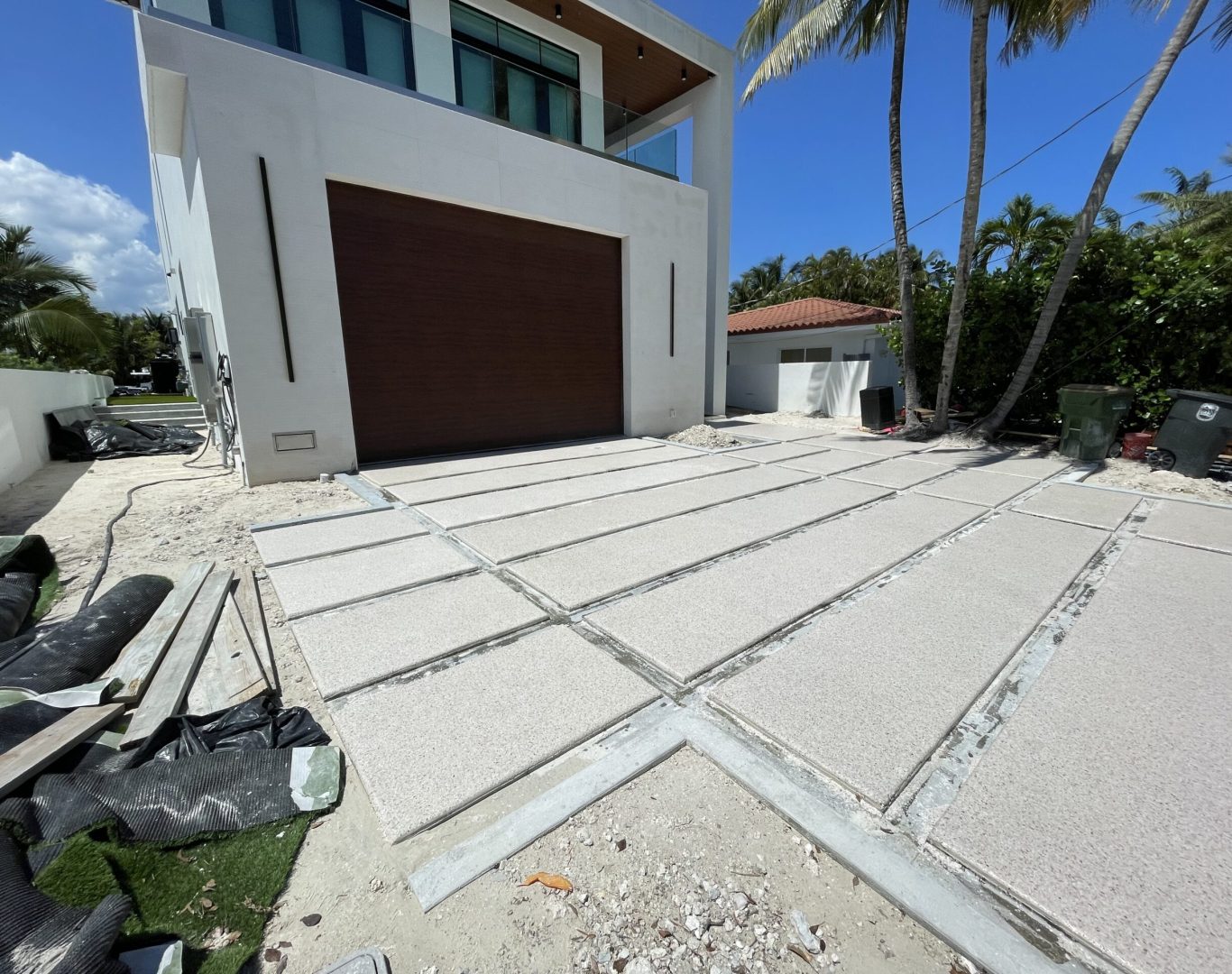 Installer detailing Residential Epoxy Garage Flooring edges inside a Kendall, FL home garage during final coating work