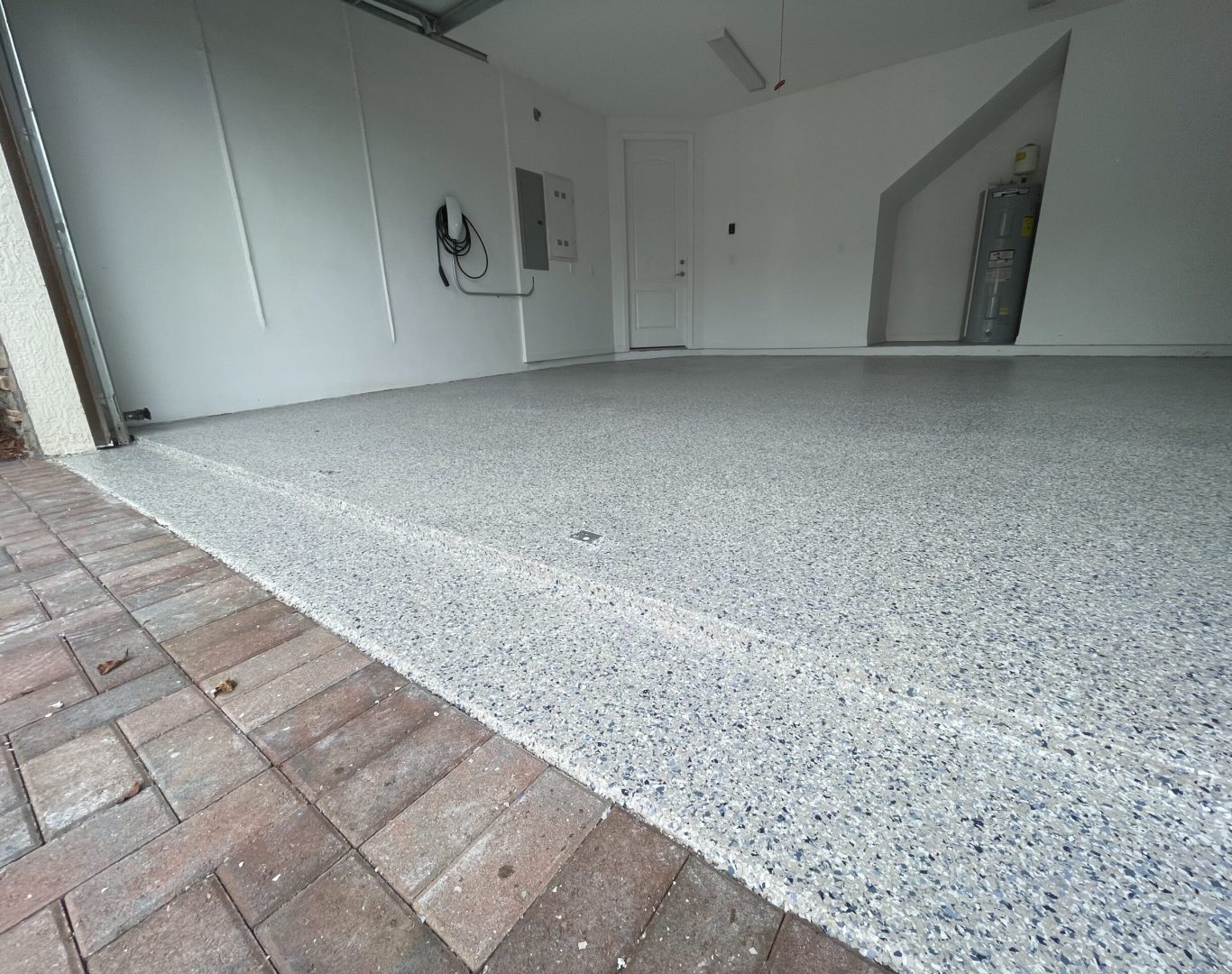 Skilled technician applying premium epoxy coating, ensuring a safe and attractive garage floor in Doral, FL